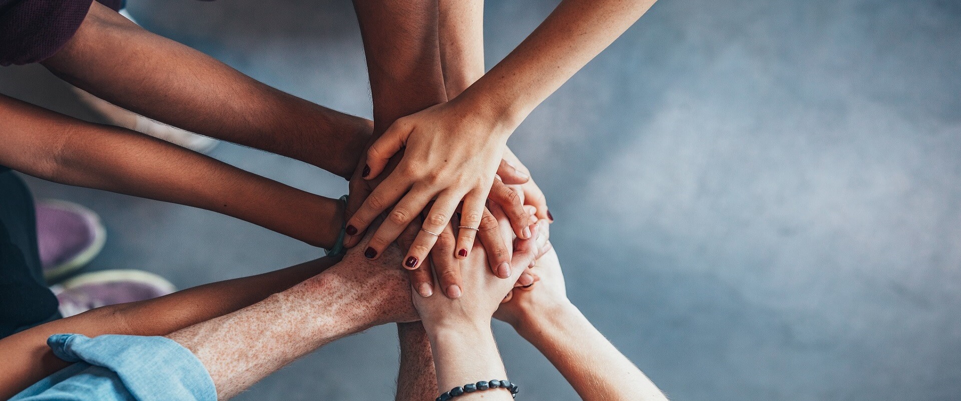 Close,Up,Top,View,Of,Young,People,Putting,Their,Hands